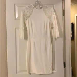 White body con dress with lace sleeves and back.